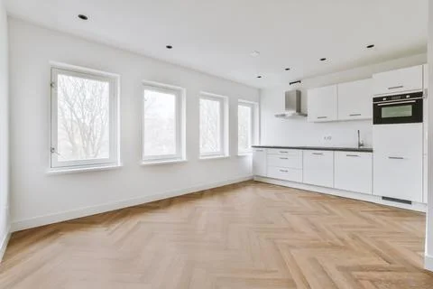 Spacious bright white kitchen with windows Stock Photos