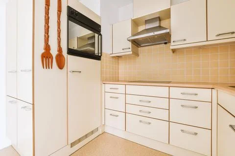 Spacious bright yellowish kitchen with windows Stock Photos