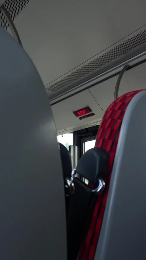 Spacious bus cabin showcasing decorative upholstery and overhead signage Stock Footage 335368272
