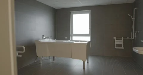 Spacious Care Bathroom With Height Adjustable Bathtub, Bright Window Daylight Stock-Footage 340360406