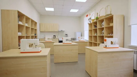 Spacious classroom filled with sewing machines on tables Stock Footage 333904073