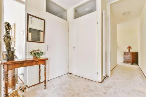 A spacious corridor with a carpet floor in a white design Stock Photos