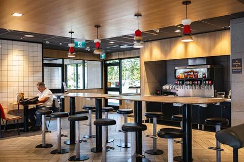 Spacious dining area with a communal table and comfortable seating in a res.. Stock Photos