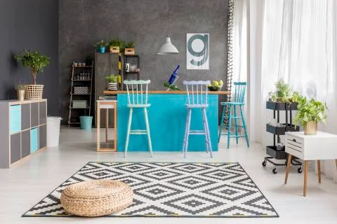 Spacious dining room with pouf Stock Photos