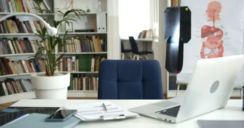 Spacious doctors empty office with laptop and smartphone on table x - ray images Stock Footage 149045885