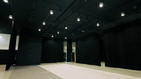 Spacious empty black box theatre or exhibition space with black curtains and Stock Footage 333813500