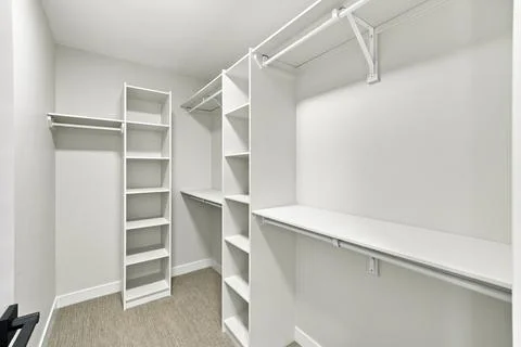 Spacious, empty closet with white shelving units Stock Illustration