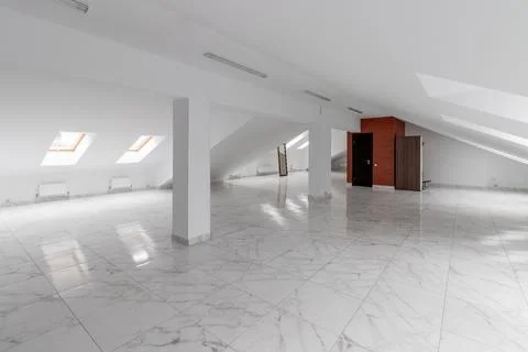 Spacious empty hollow attic with tiled floor Stock Photos