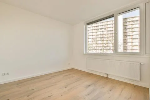 Spacious empty room with a large window Stock Photos