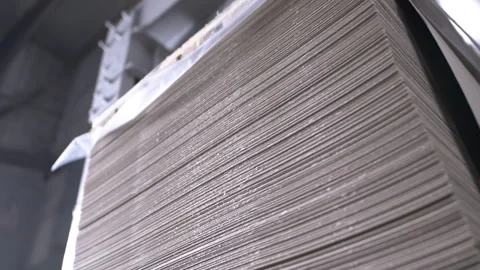 Spacious factory warehouse with stack of cardboard sheets Vídeos de archivo 303104676