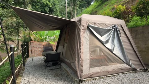 Spacious glamping tent with an extended canopy and outdoor seating area Stock Footage 337982301