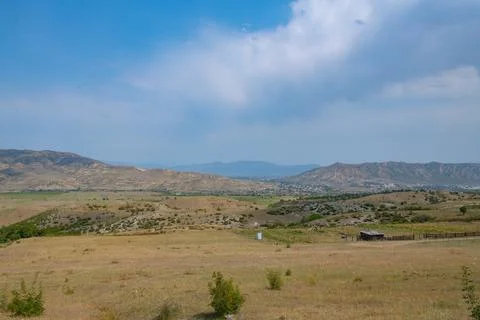 Spacious green fields and mountains in georgia in summer Stock Photos