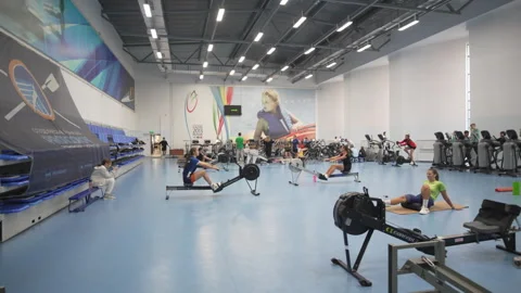 Spacious hall filled with athletes on rowing machines Stock Footage 316751885