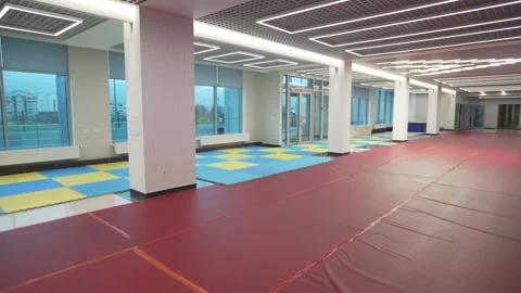 Spacious hall glows with panoramic windows and soft PVC mats Stock Footage 316754001