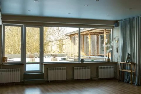 A spacious hall with large windows and radiators. Panoramic windows made of f Stock Photos