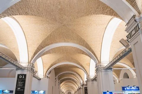 Spacious hallway with high, arched ceilings and columns made of light-color.. Stock Photos