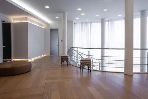 Spacious hallway of upper floor in large mansion with wide window Stock Photos