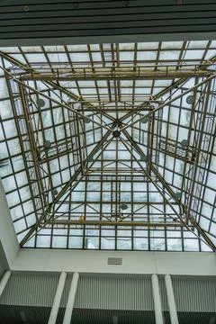 A spacious interior with a central geometric lattice structure, composed of m Stock Photos