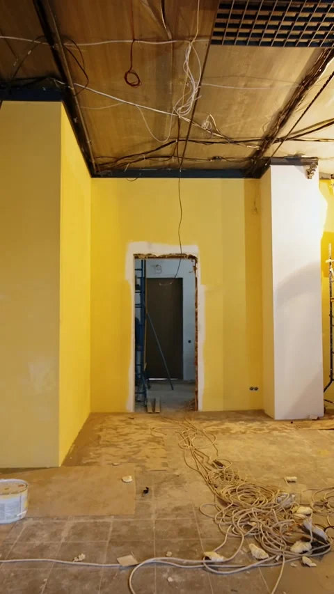 Spacious interior of the room with a wide column in the middle. Three workers Stock Footage 337717325