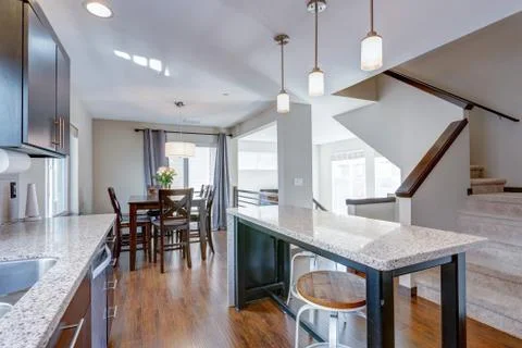 Spacious kitchen with open floor plan features chocolate brown cabinets and a Foto stock