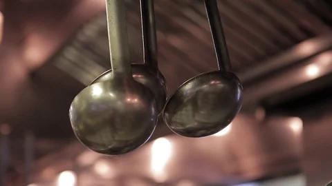 In a spacious kitchen, there are sets of metal ladles. Stock Footage 76447676