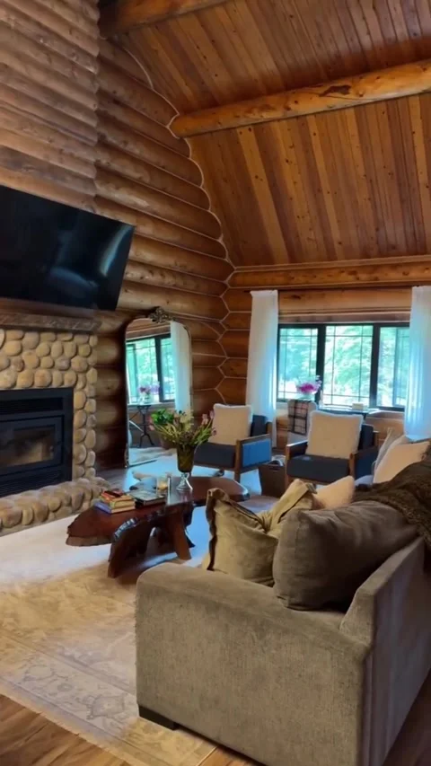 Spacious Living Room With a Stone Fireplace and Log Walls Video stock 342264019