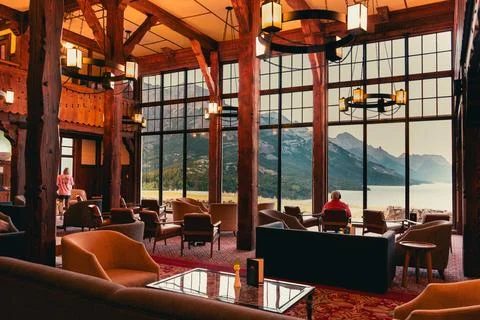 Spacious lodge interior with stunning mountain view, perfect relaxation. Stock Photos