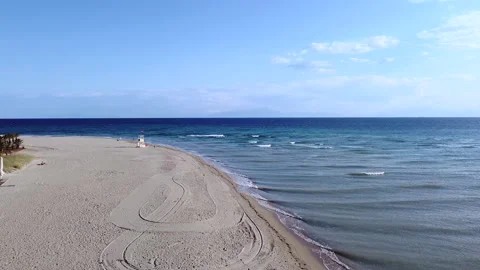 Spacious long sand beach with life guard house and tranquil sea. Aerial view Stock Footage 170994768