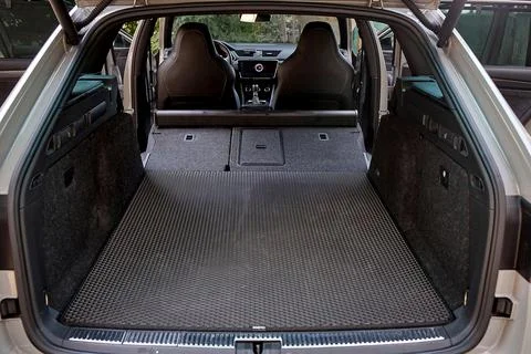 Spacious luxury car trunk with folded rear seats Stock Photos