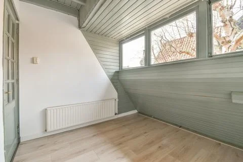 Spacious mansard styled empty room Stock Photos