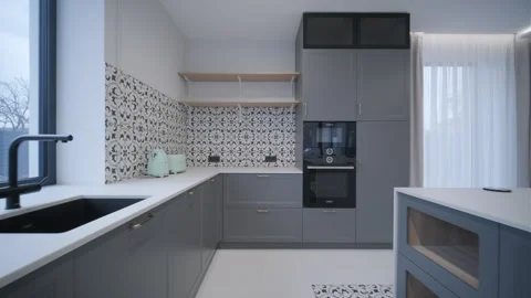 Spacious modern kitchen with gray cabinetry, patterned backsplash Stock Footage 270089419