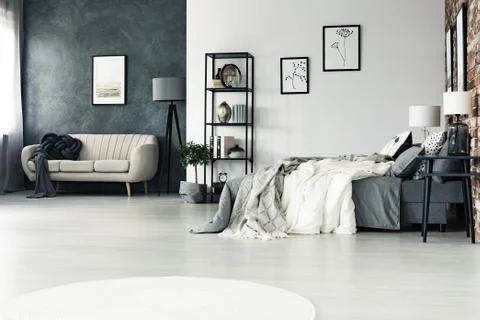 Spacious multifunctional grey bedroom Stock-Fotos