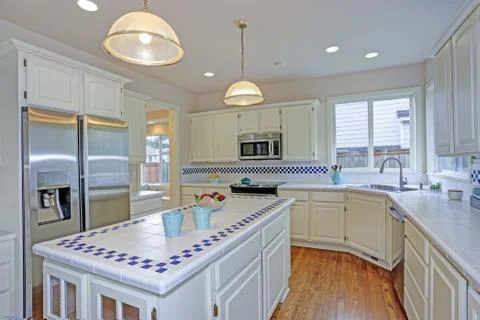 Spacious open floor plan kitchen interior with white shaker cabinets framing  Stock Photos