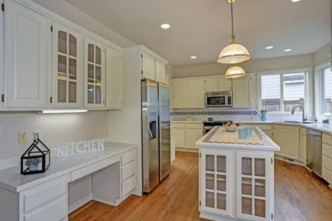 Spacious open floor plan kitchen interior with white shaker cabinets framing  Stock Photos