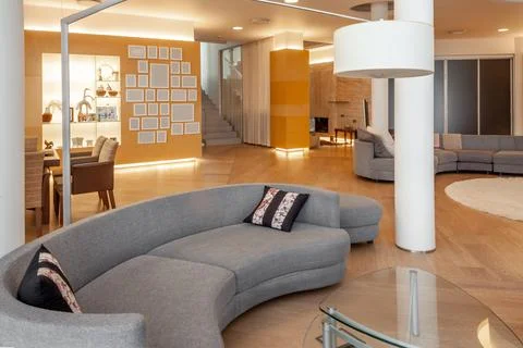 Spacious open plan living room with soft couches in sitting area Fotos de archivo