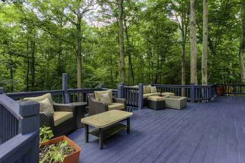 Spacious Outdoor Deck In A Forest Setting With Comfortable Seating Furniture Stock Photos