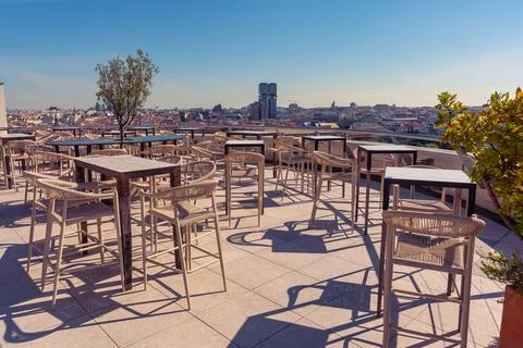 Spacious rooftop terrace with empty seating and a wide panoramic view of th.. Stock Photos