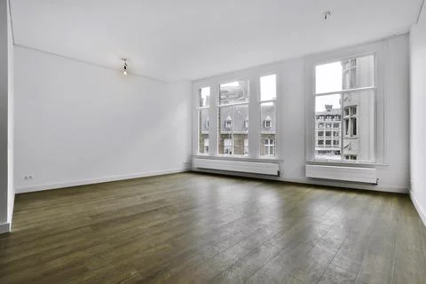 A spacious room with large windows Stock Photos