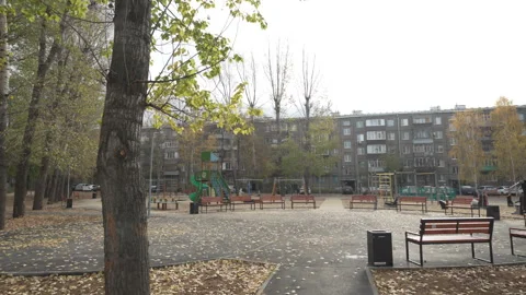 Spacious square features benches and playground for all ages Stock Footage 306457254