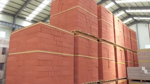 A spacious storage area that features neatly stacked red bricks inside an Stock Footage 312811329
