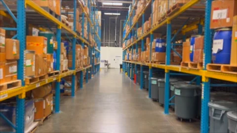 Spacious warehouse with high shelves filled with boxes, indicating efficient Video stock 301521321