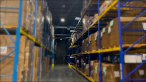 Spacious warehouse with high shelves filled with boxes, indicating efficient Stock Footage 301521360