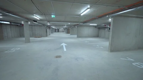 Spacious well-lit underground car park with free parking spaces Stock Footage 86531485