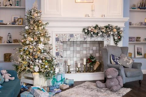 Spacious white light bedroom in a loft style with a decorated Christmas spruc Stock Photos