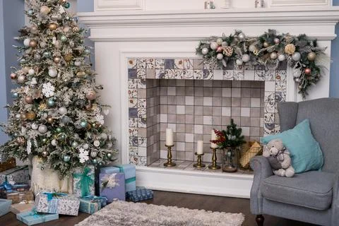 Spacious white light bedroom in a loft style with a decorated Christmas spruc Stock Photos
