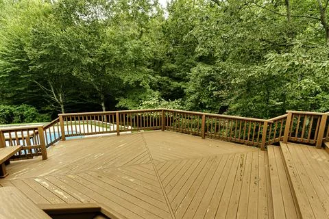 Spacious Wooden Deck With A Pristine View Of Lush Greenery And Trees. Stock Photos