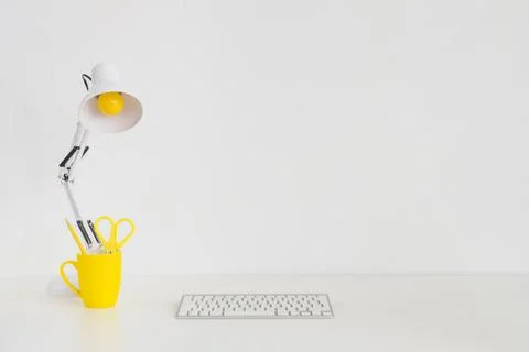 Spacious workplace with yellow mug keyboard. High quality and resolution Stock Photos