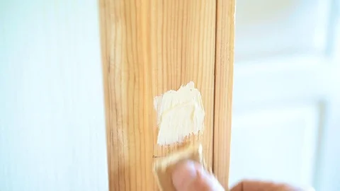 Spackling a round countersunk hole with screw head in door frame Vídeo Stock 74918963