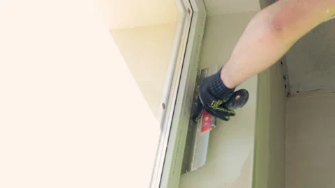 Spackling of window slopes. The master's hand smoothes the slope with a spatula Stock Footage 196478130