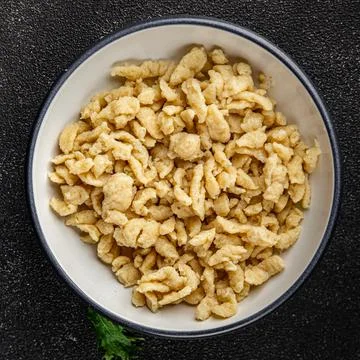Spaetzle egg pasta irregular shape fresh meal food snack on the table copy .. Stock Photos